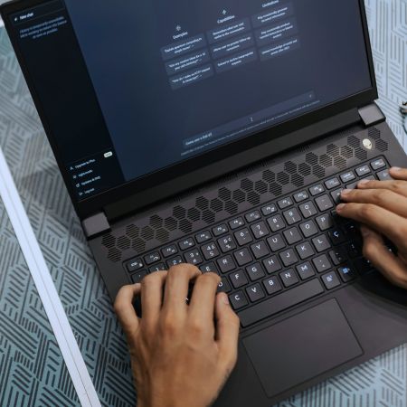 Hands-using-laptop-with-ai-generator-on-screen
