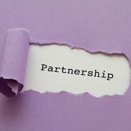 Torn-purple-paper-revealing-the-word-partnership